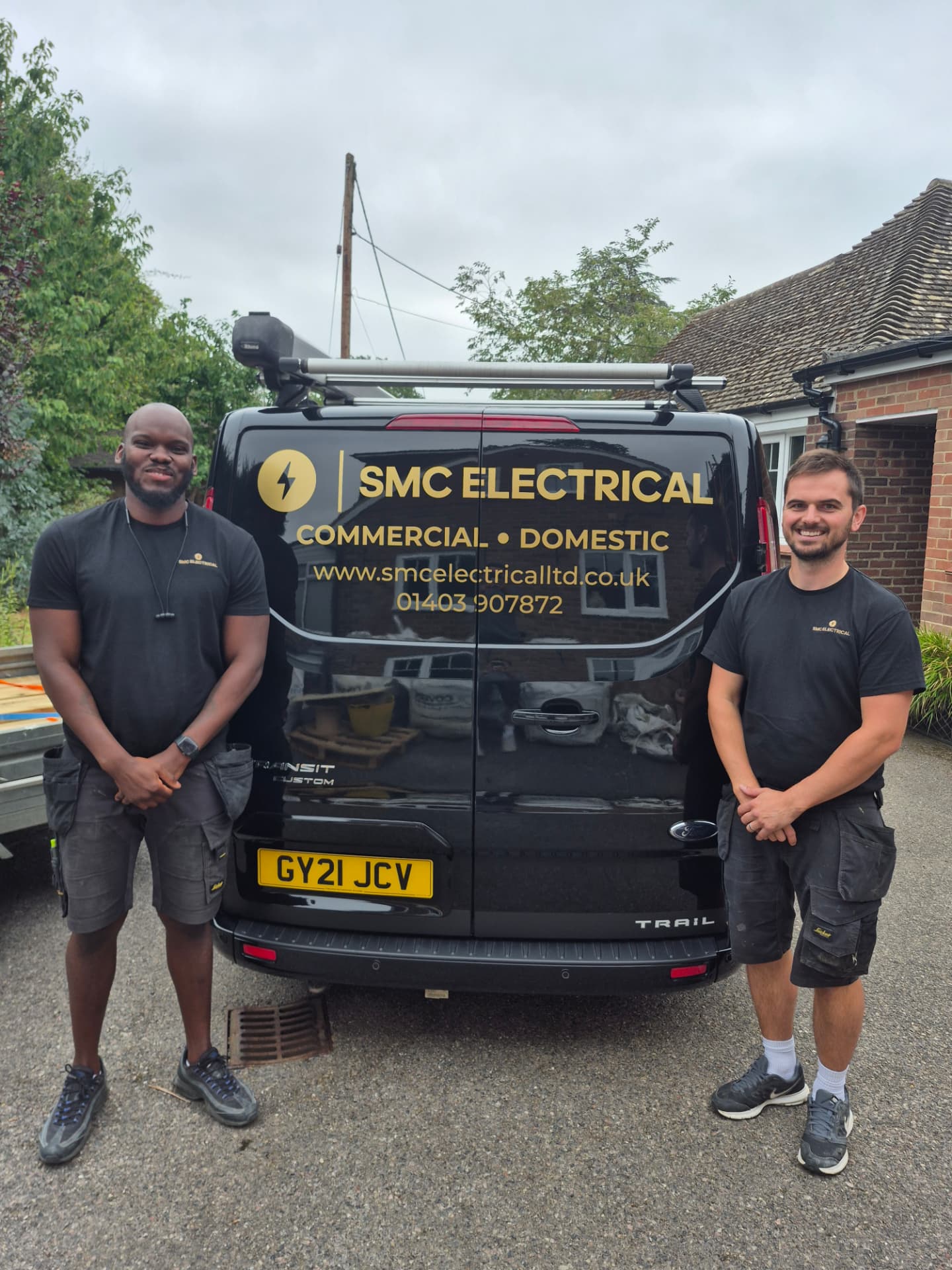 Stephen and Omar from SMC Electrical beside their van